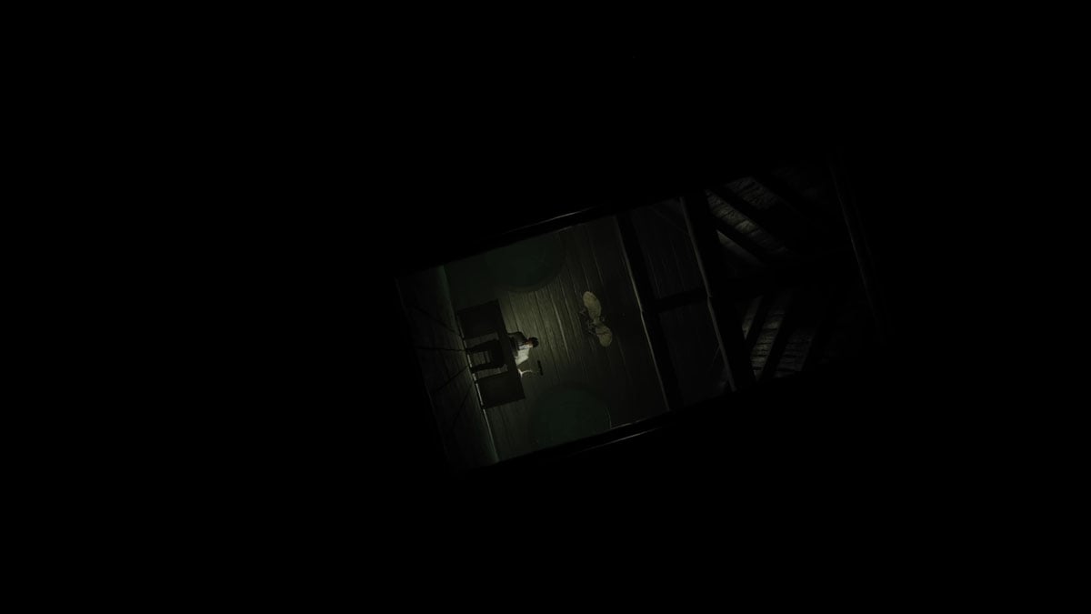 A screenshot of a man sitting at a desk in Alan Wake 2.