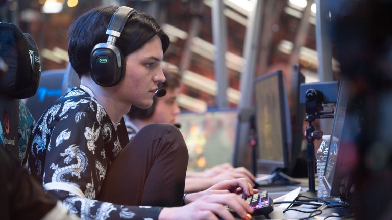 A Team Spirit player sits in their chair in the booth at TI 2023.