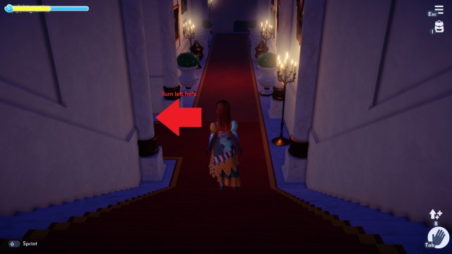 A Disney Dreamlight Valley screenshot showing the player standing on stairs preparing to turn left toward the garden, which is marked with an arrow.