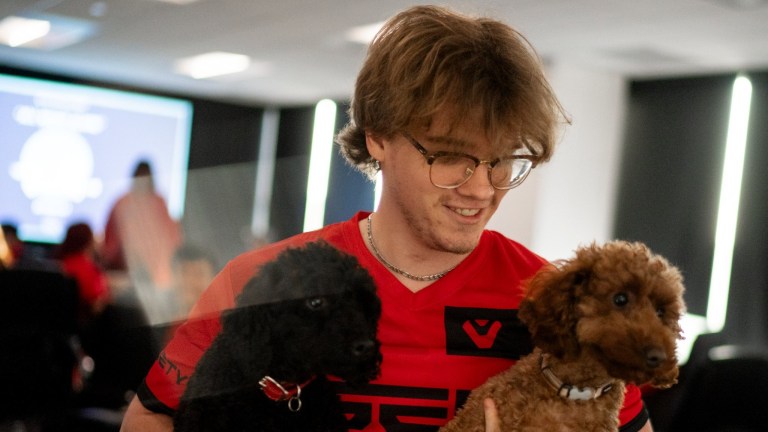 Zellsis hugs two dogs at the Sentinels and Moist x Shopify Rebellion showmatch