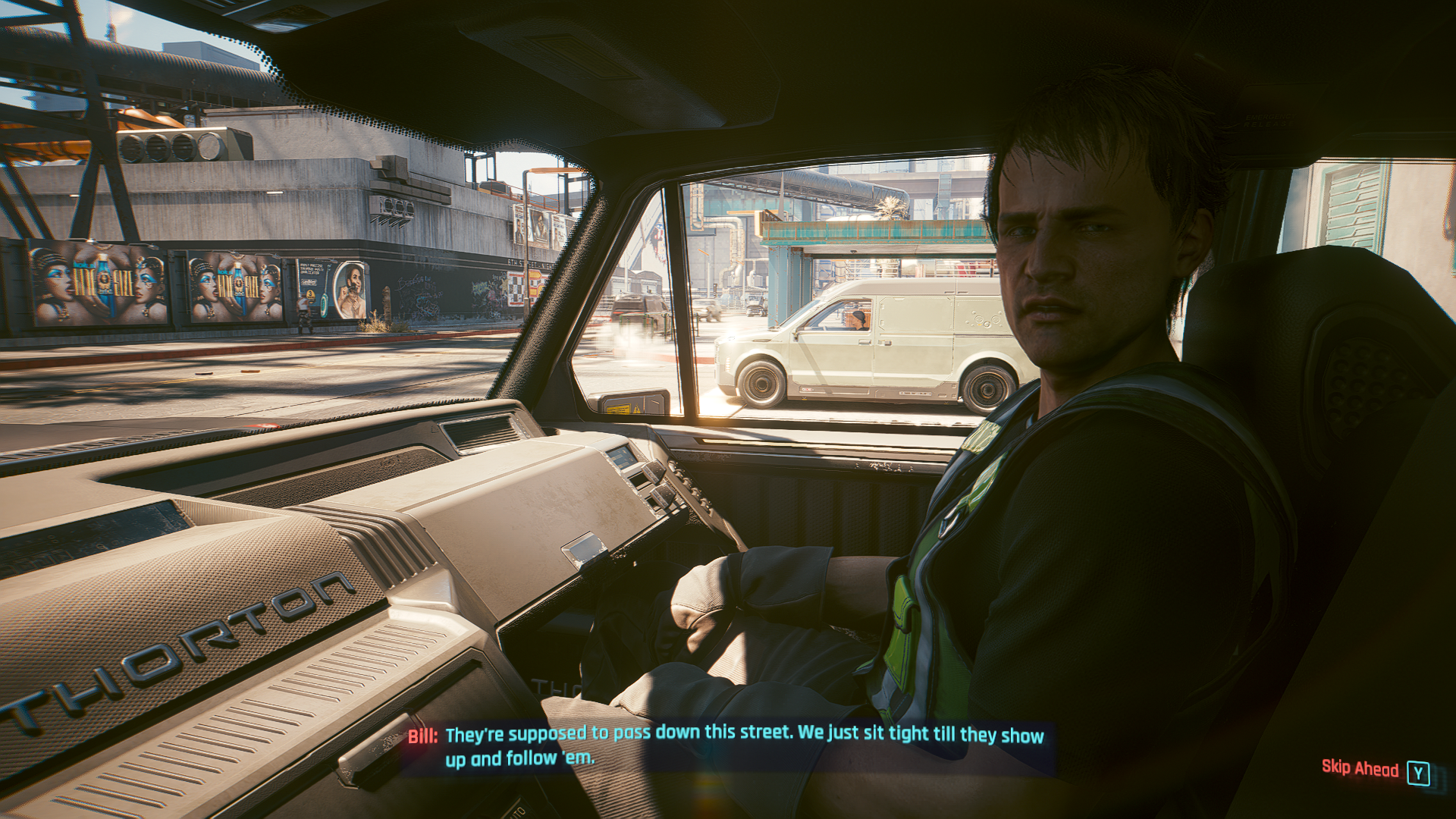 Bill Jablonsky sitting in the passenger seat of his truck in Cyberpunk 2077. It is a bright, sunny day.