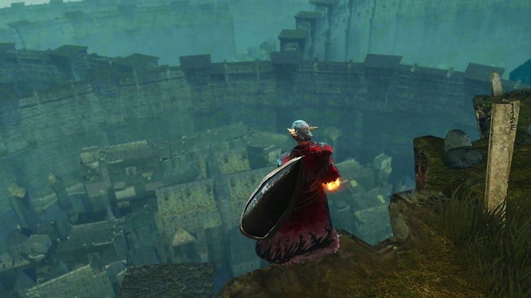 A Dark Souls character in red robes looking out over the 'Other Burg' from Firelink graveyard