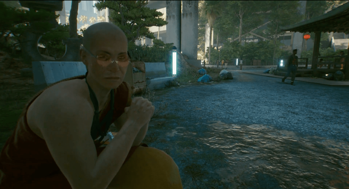 The Zen Master from Cyberpunk 2077 sits on a bench in the Imagine quest.