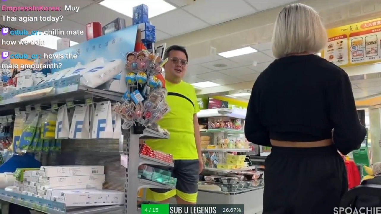 There is a shot of a man peaking behind a market stand looking at the viewer. There is a woman with her backed turned.