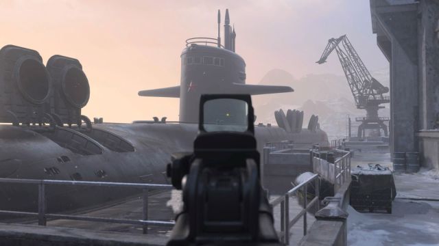 Image from the Sub Base map with the player aiming down an SMG onto the sub in the background. There is a sunrise happening in the back with the sub sitting docked at the port.