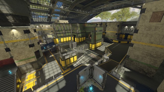 A birds eye view of The Pit, a Halo 3 map, remade in Halo Infinite's Forge. It features a series of military buildings made of concrete and painted in olive green and yellow.