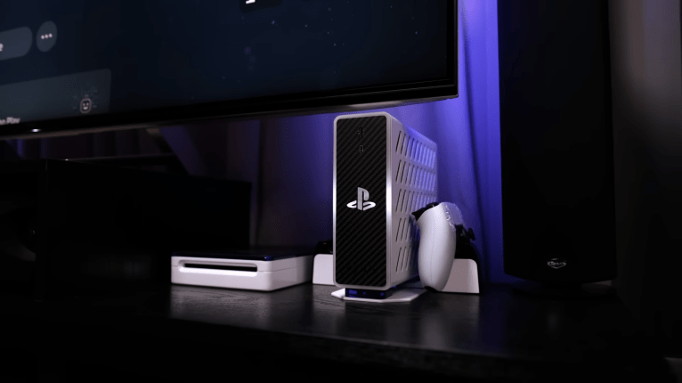 A small white, silver and black box sits prominently amongst other objects underneath a television screen.