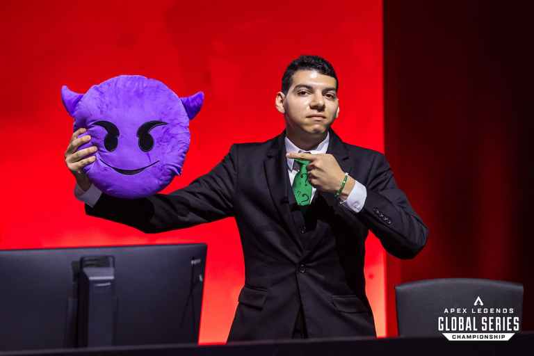 Oxygen Esports coach Anthony "Psykho" Vicente points to a devil emoji plush at the 2023 ALGS Championship.