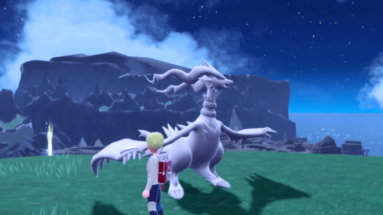 Reshiram standing in the grass near a trainer in Pokémon Scarlet and Violet