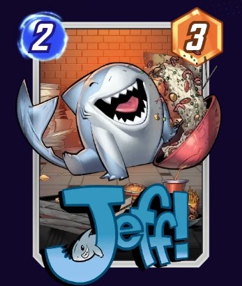 Jeff the Baby Land Shark card, while sitting on the floor.