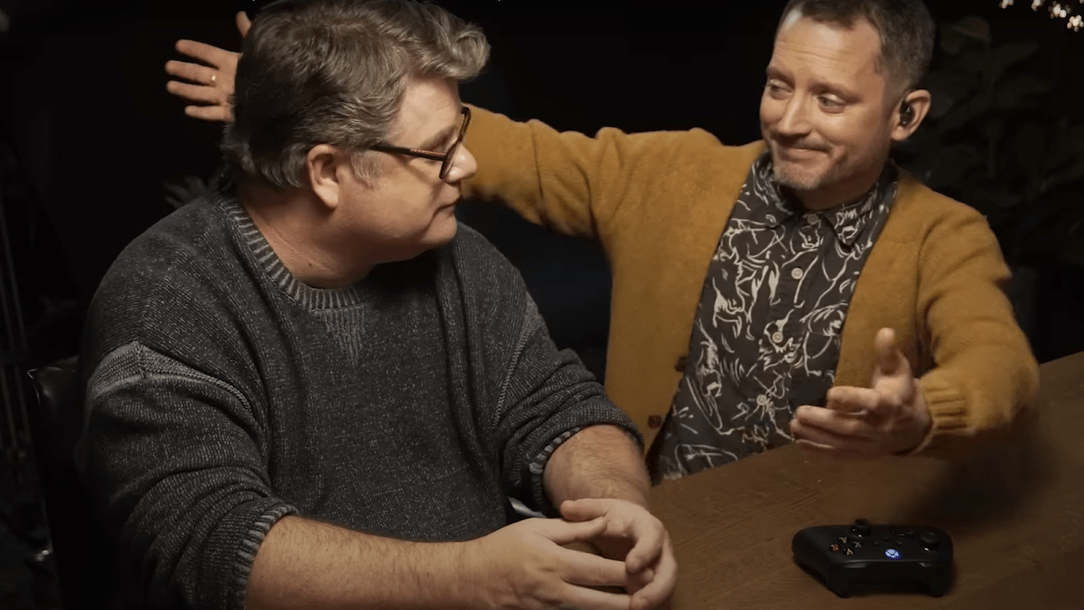 Sean Astin and Elijah Wood extending each other a hug after playing Baldur's Gate 3.