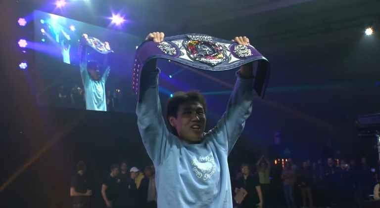 Milala holding championship belt at TFT Vegas Open