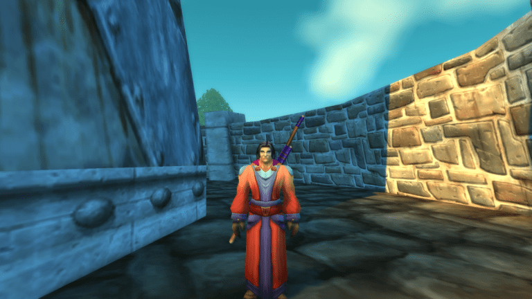 Image of a man in red and blue robes standing near a castle in WoW SoD.