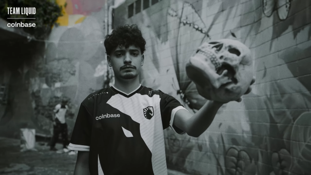 Skullz, a Counter-Strike player for Team Liquid, holds a skull in a cobblestone street.