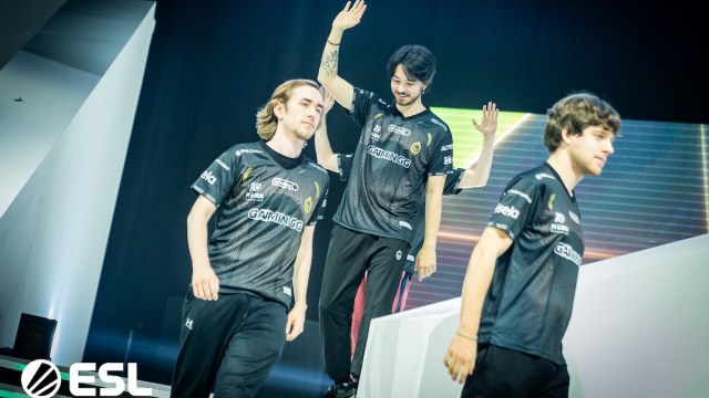 Gaimin Gladiators and Quinn walking off stage at Dota 2's ESL One Kuala Lumpur.