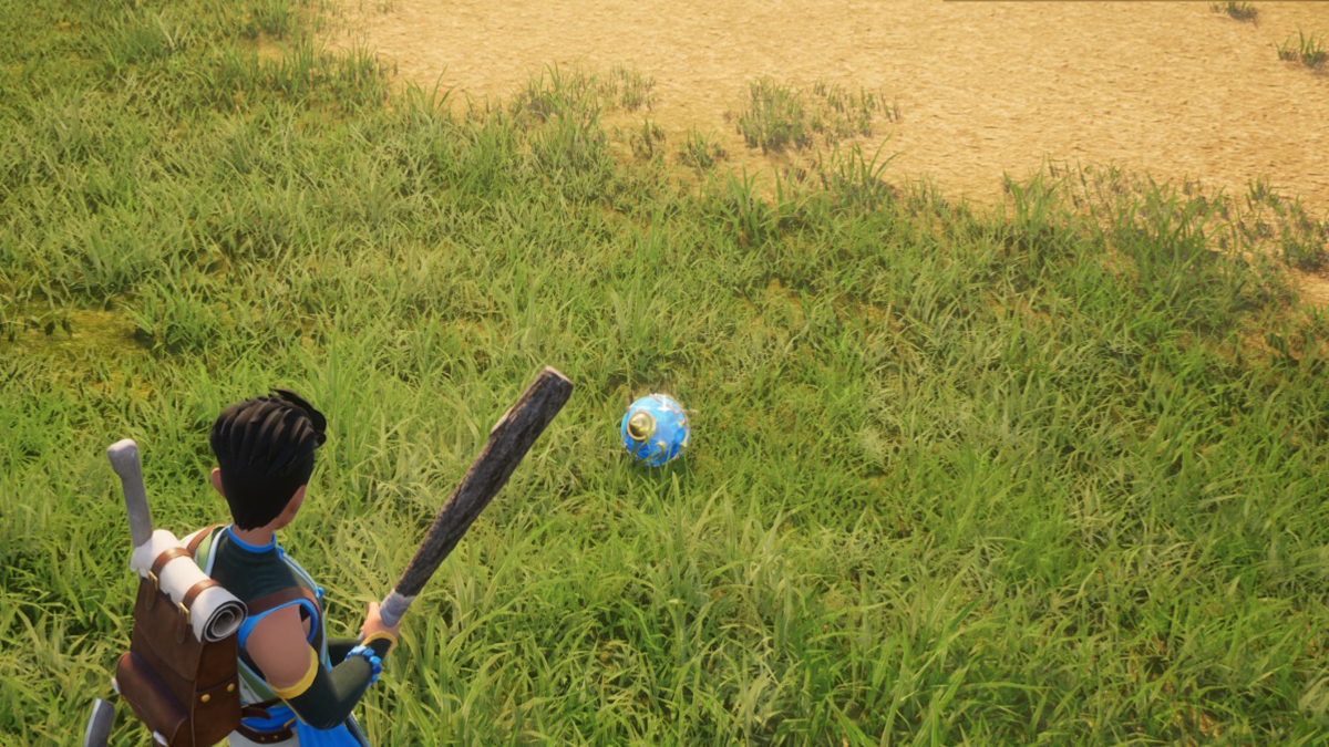 A player in Palworld looking at a blue Pal Sphere on the ground.