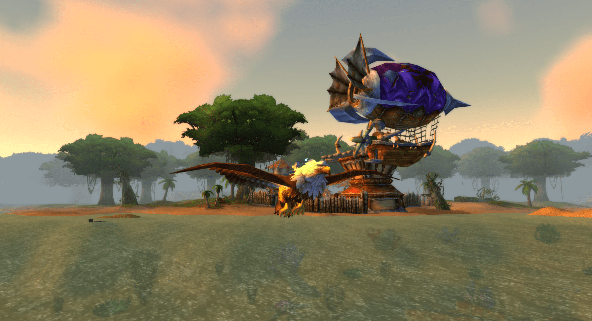 A gnome in World of Warcraft flies along the coast of Stranglethorn Vale towards Booty Bay in WoW Classic on a gryphon