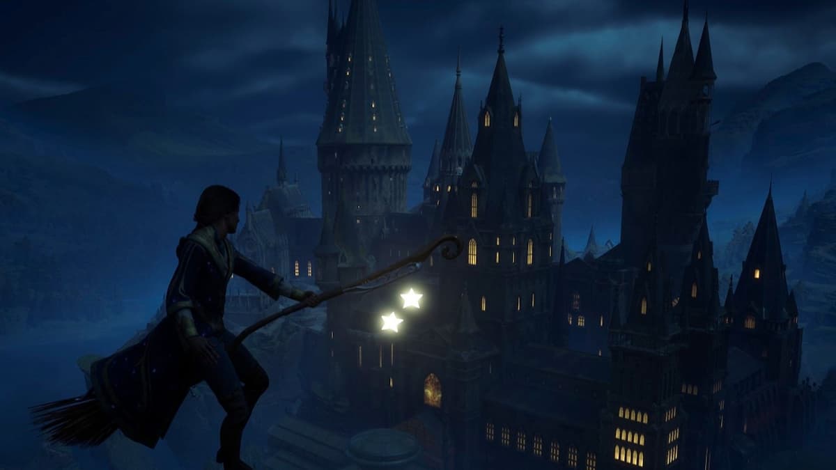 The player flying on a broom by Hogwarts at night.