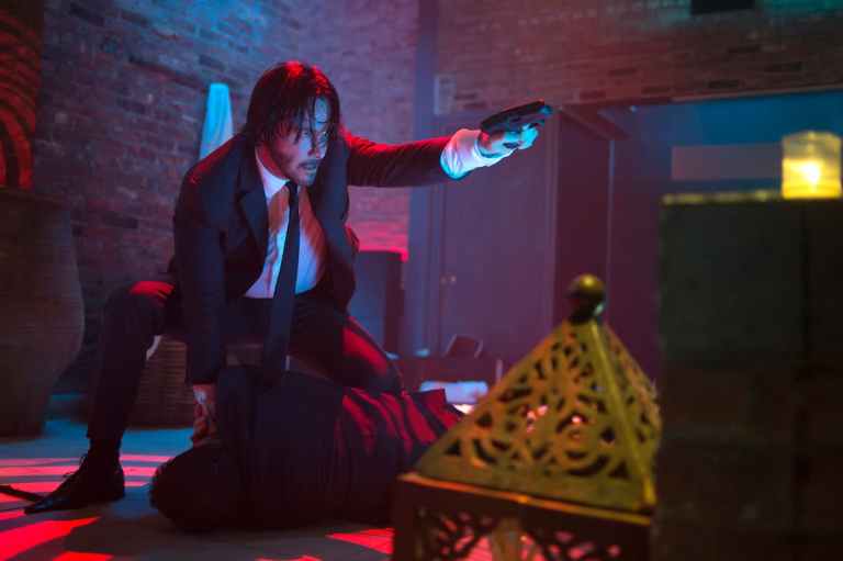 John Wick takes aim at an enemy.