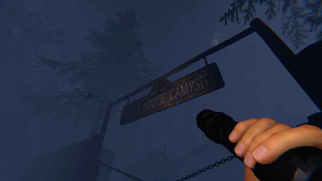 The player holding a flashlight and looking at the Maple Lodge Campsite sign.