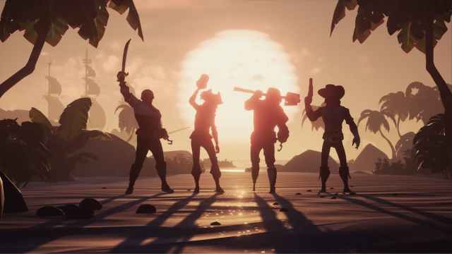 A crew of four pirates standing in the sunset