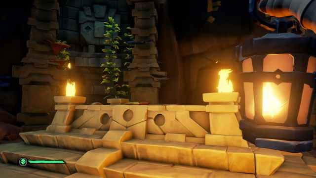 A Vault in Sea of Thieves lit by a lantern and flame.