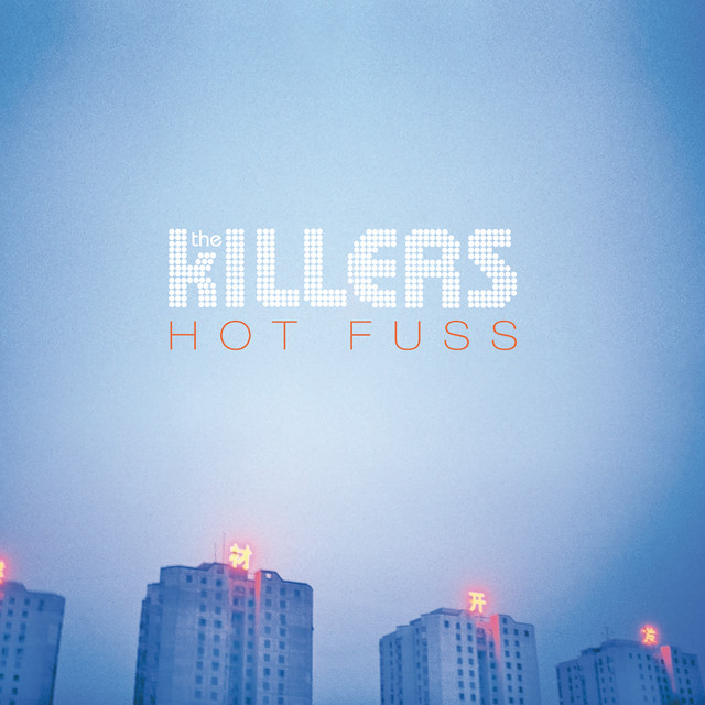 An image of the Mr. Brightside cover art, which features buildings with blue lighting. 