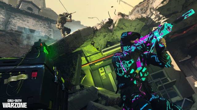 An operator in neon-like paint defends a bombsite from enemies in Warzone.