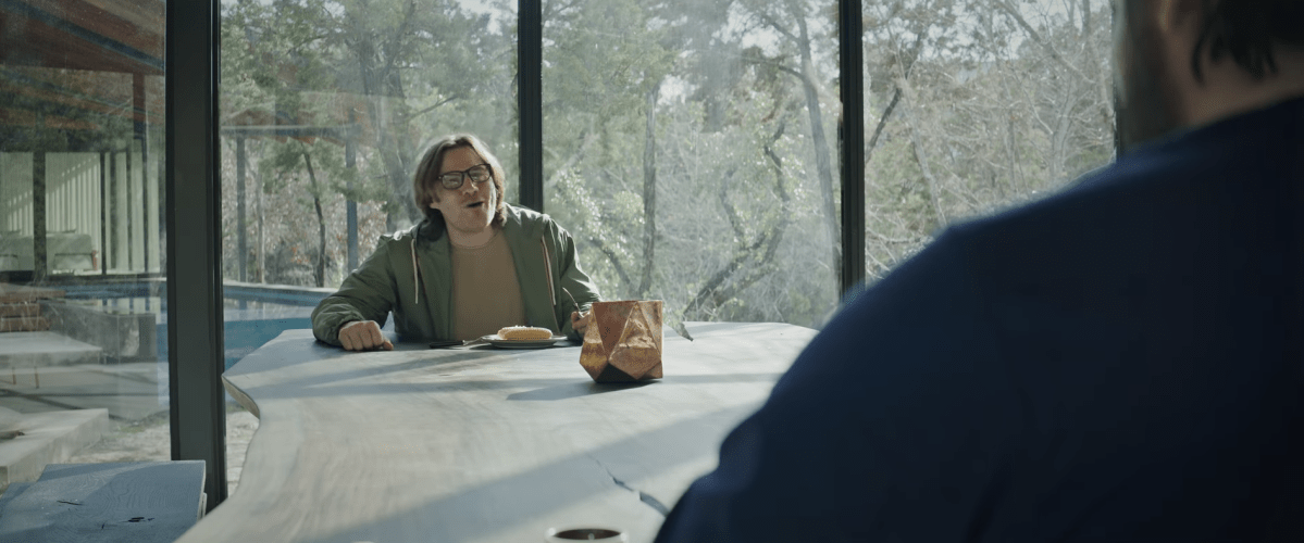 Will Neff stares at Cyr across a table in a short film created for his org announcement.