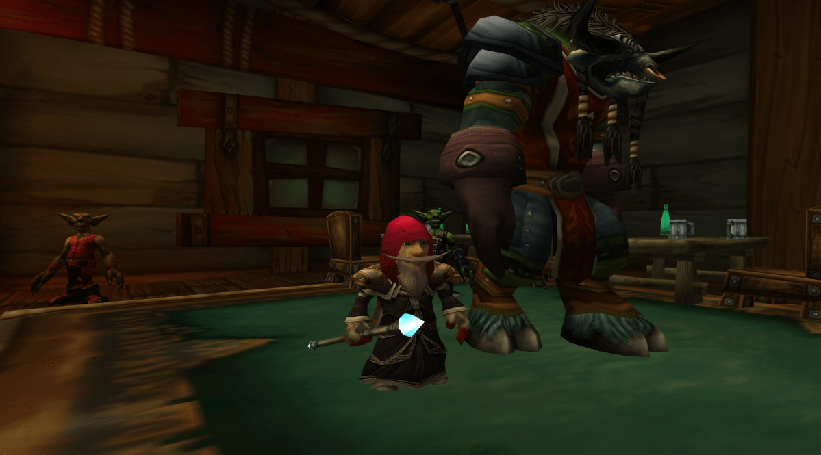 A gnome and a tauren standing in the Booty Bay Salty Sailor Tavern in WoW Classic