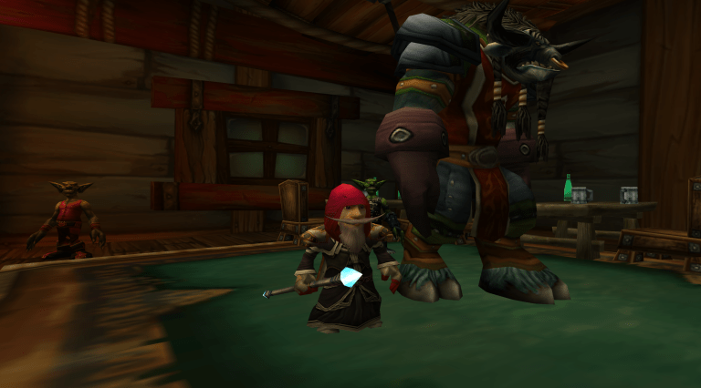 A gnome and a tauren standing in the Booty Bay Salty Sailor Tavern in WoW Classic