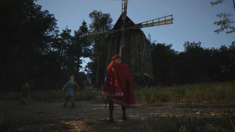 A character in a cloak stands outside a windmill