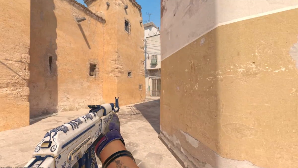 A player with an AK in their left hand on Dust 2 in CS2.