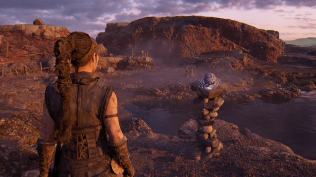 Senua looks at a sphere in a pedestal puzzle