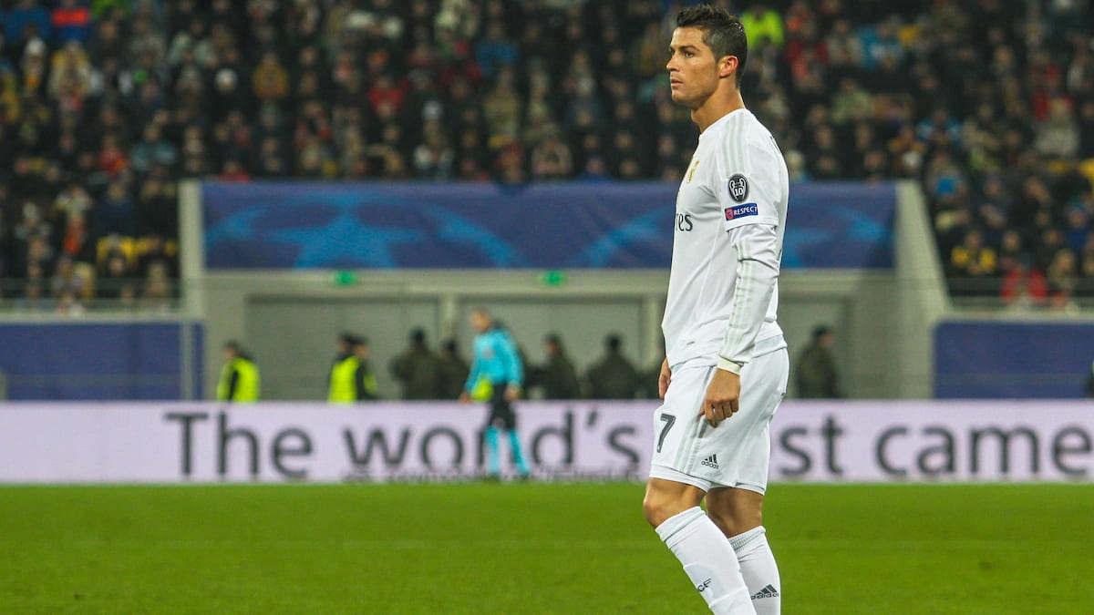 Cristiano Ronaldo wearing a Real Madrid jersey on the pitch.