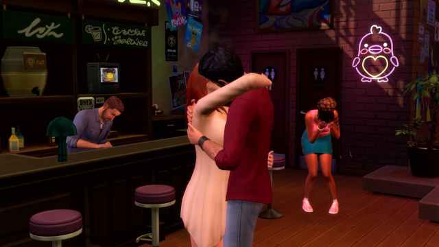 Two Sims kissing at a bar and one Sim crying in the back.