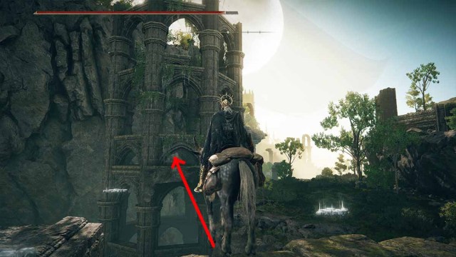 Elden Ring character looking at broken bridge leading to tower with red arrow pointing