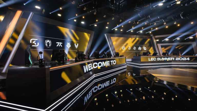 The LEC stage with yellow lights flashing and the team's logos in the background.