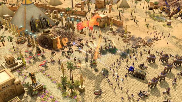 Age of Mythology Retold gameplay screenshot showing a desert town being attacked