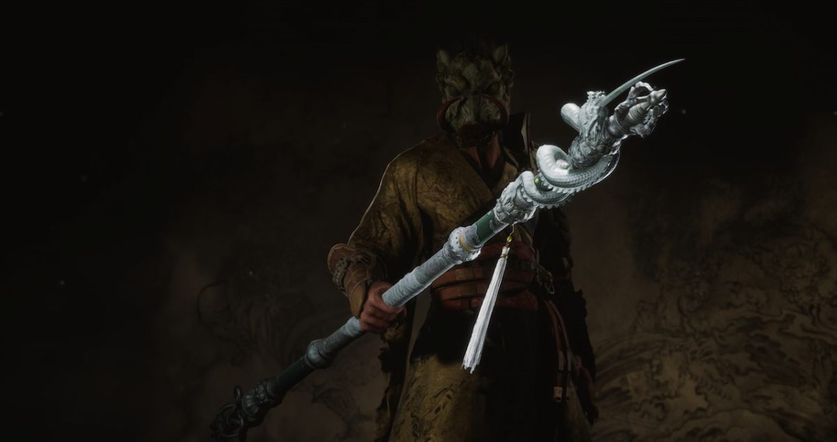 The Destined One holds the Kang-Jin Loong staff with its distinctive draconic silver details.