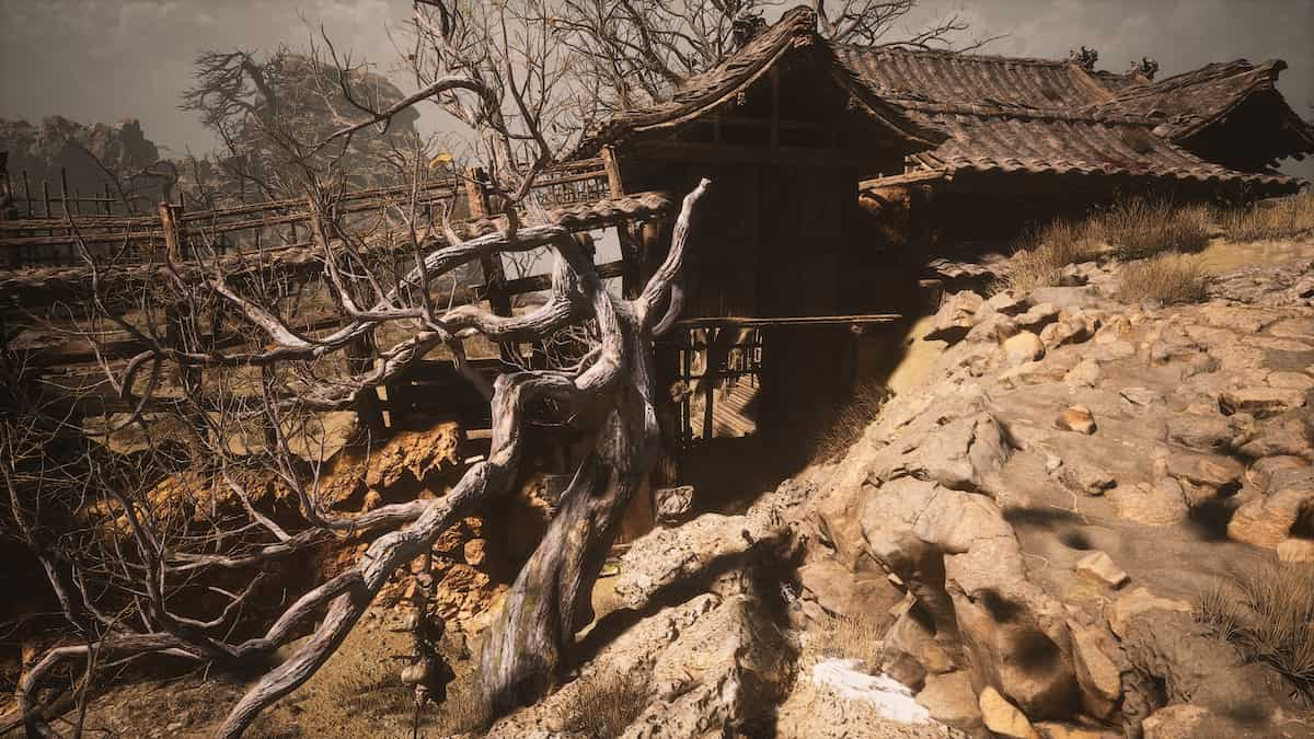 A house in a desert village with a wooden bridge leading to it from the left and a flimsy barricade to the right. This house leads the way to the second Ma Tianba location in Black Myth Wukong.