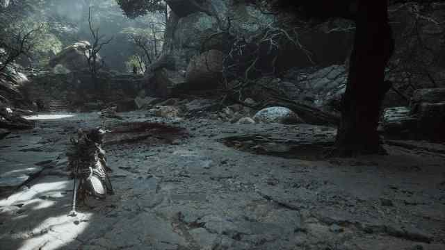 The Destined One stands in front of a Luojia tree, with the Mountain Trail shrine visible in the background in Black Myth: Wukong.