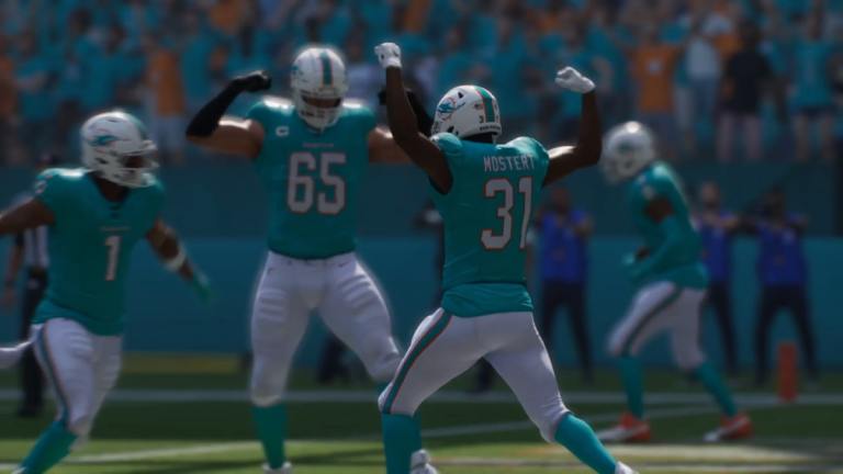 Players in Madden 25 Ultimate Team wearing a Miami Dolphins blue jersey celebrate.