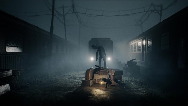 Two characters in REANIMAL hiding from a monster behind some boxes in a train yard