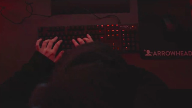 Overhead shot of Joel typing on the keyboard with Arrowhead mousepad visible to his right