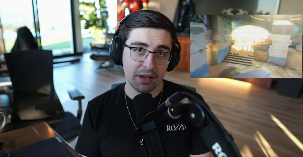 Shroud sitting at his desk, looking at the camera.