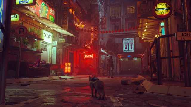 An image from Stray of the playable Cat sitting and watching a futuristic city.