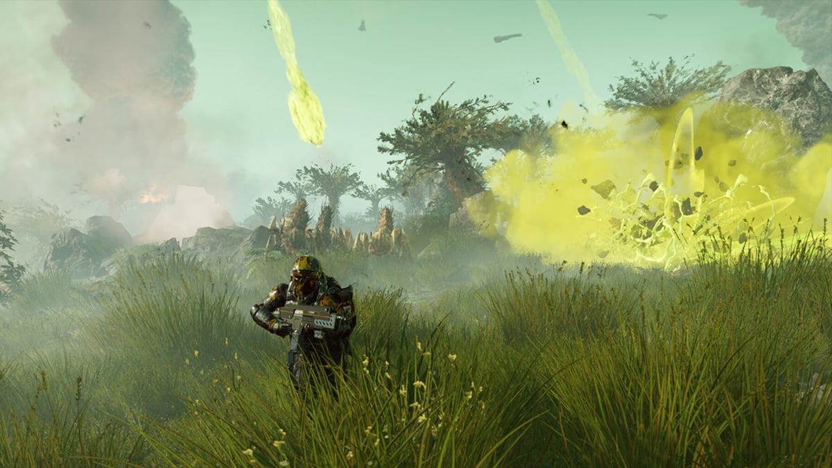 A Helldiver in full armor runs through long green grass in a field while poisonous explosions and bugs attack in Helldivers 2.