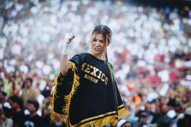 Rivers celebrates in a Mexico branded poncho at a full stadium