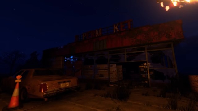 Looking at the supermarket at night, lit by a single torch